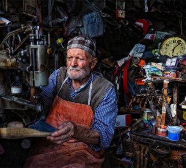 Old Turkish man manages a shoe repair shop