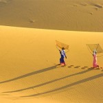 Vietnamese women cross the sand dunes