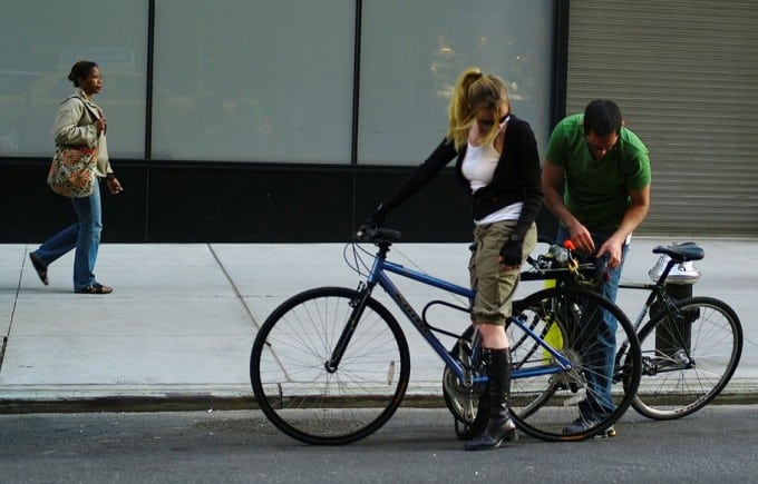 man fixes girl bicycle