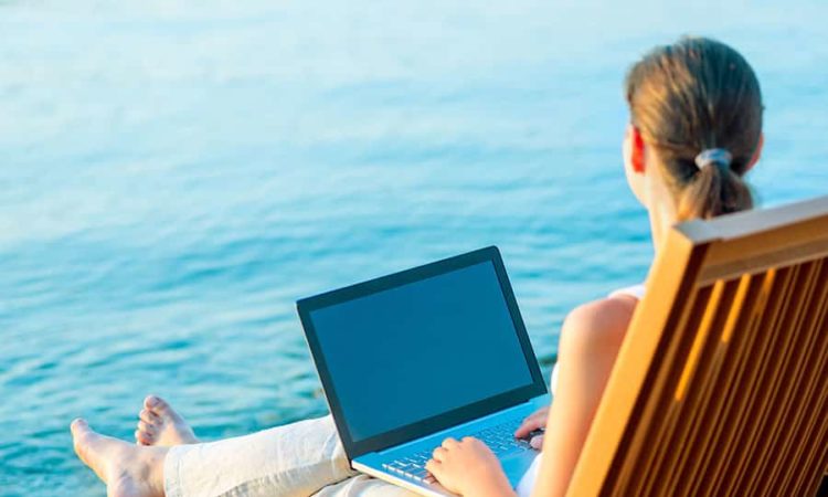 Business Woman with Laptop on beach