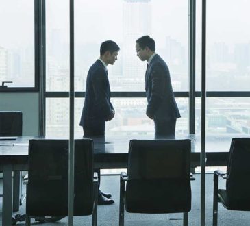 Businessmen Bowing to Each Other