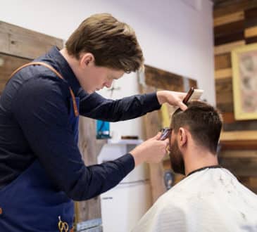 Man and barber at salon