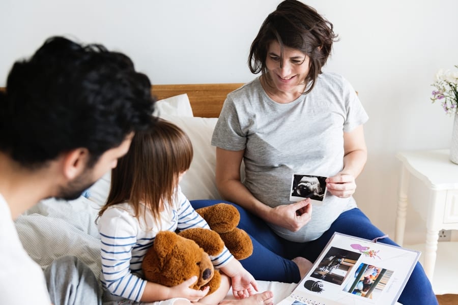 Pregnant family looking through a family photo album