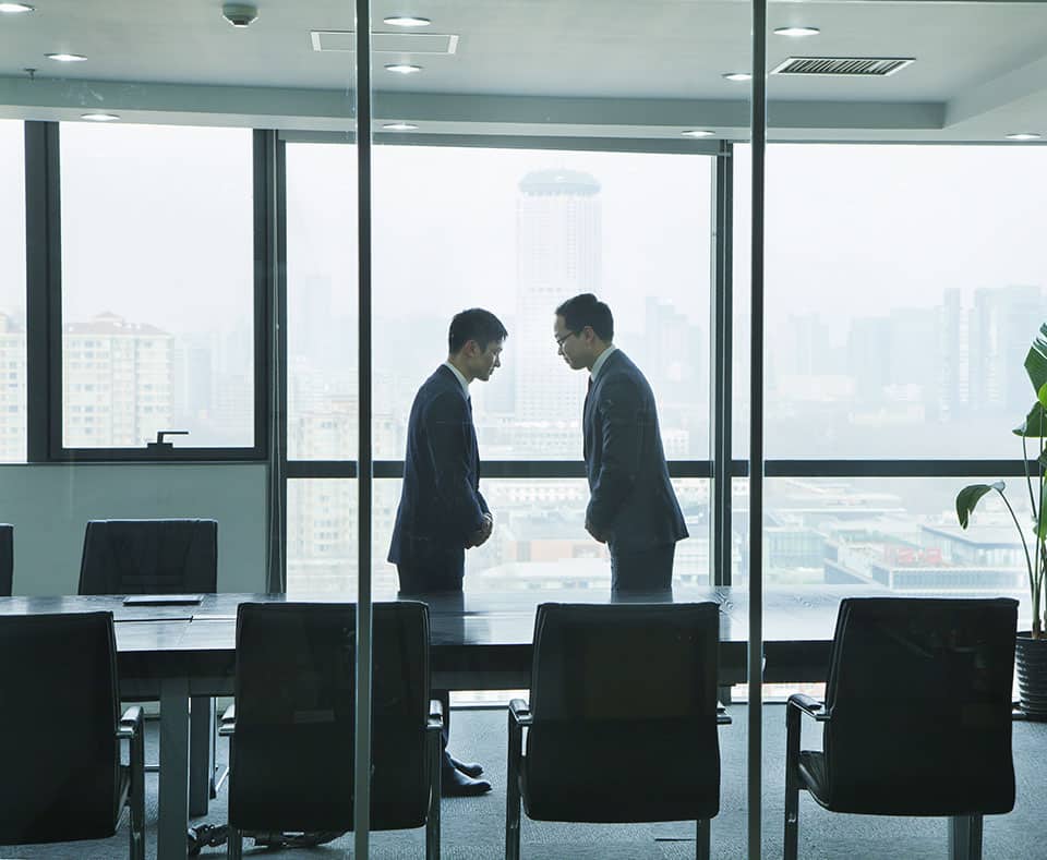 Businessmen Bowing to Each Other