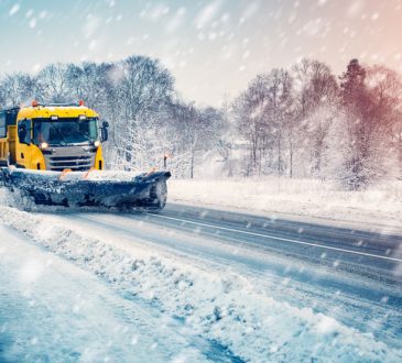 Snow plow truck cleaning snowy road