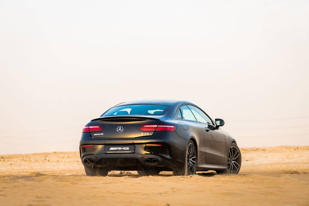 Black Mercedes Benz E53 AMG back view at Abu Dhabi Desert, United Arab Emirates