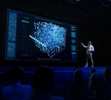 Computer Science Startup Conference: On Stage Speaker Does Presentation of New Product, Talks about Neural Networks, Shows New AI, Big Data and Machine Learning App on Big Screen. Live Event