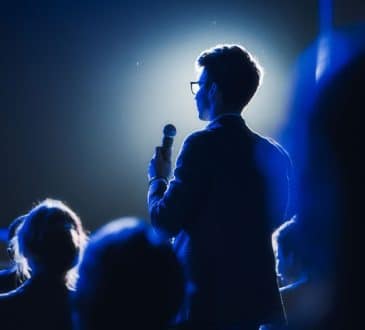 Asking a Question to a Speaker During a Q and A Session at an International Tech Conference. Tech Specialist Expressing an Opinion During a Global Business Summit.