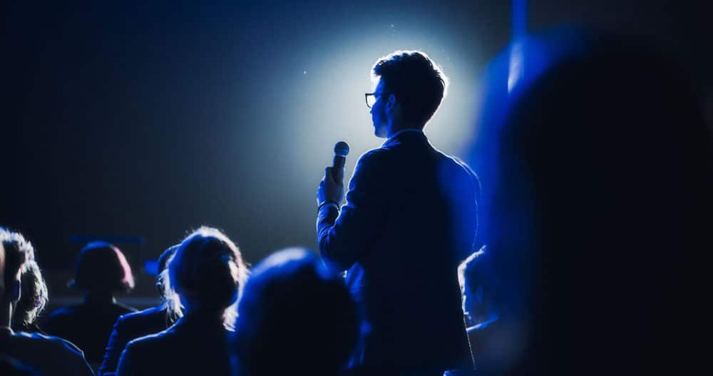 Asking a Question to a Speaker During a Q and A Session at an International Tech Conference. Tech Specialist Expressing an Opinion During a Global Business Summit.