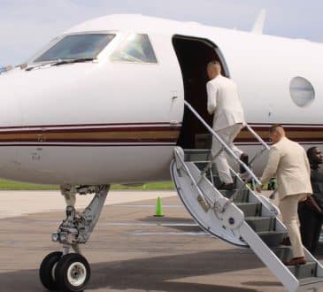 Business people on airplane runway