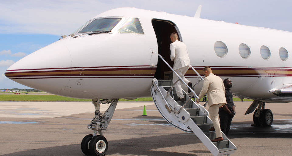 Business people on airplane runway