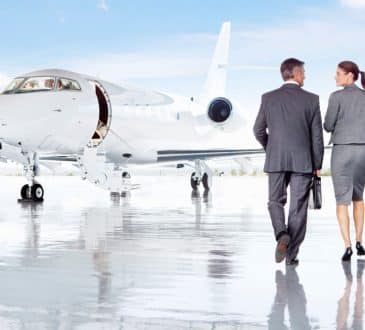 Business people on airplane runway