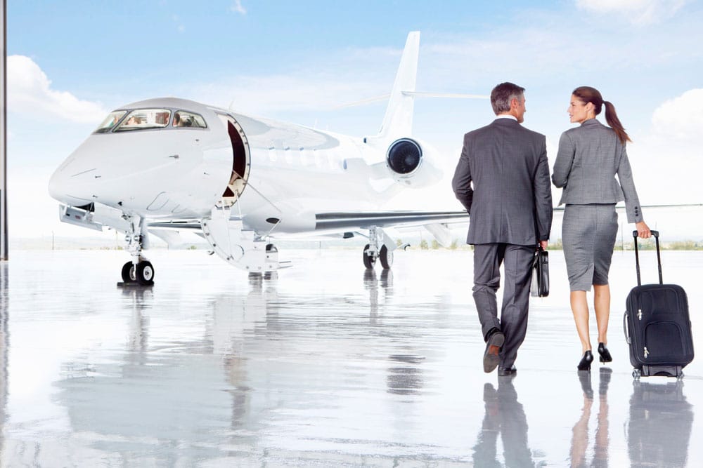 Business people on airplane runway