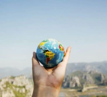 Person Holding World Globe