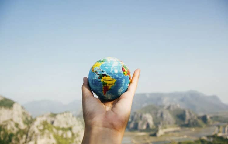 Person Holding World Globe