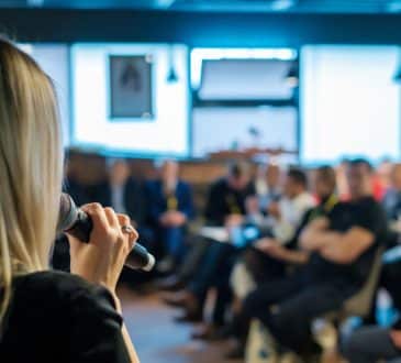 Female presenter speaks to audiences at workshop